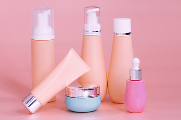 blank bottle packaging with natural cosmetic cream, serum, skincare, lotion, tonic. bio organic product on peach color background. spa concept. Plastic bottle label design. Cosmetic design template.