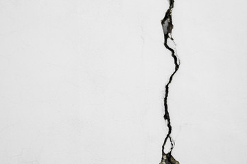 Cracked wall. Background. crack on a white concrete wall.