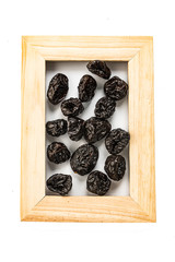 prunes dried fruits in a frame for a photo isolate on a white background