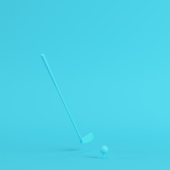 Golf club with golf ball on bright blue background in pastel colors. Minimalism concept