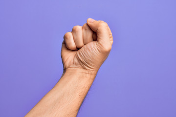 Hand of caucasian young man showing fingers over isolated purple background doing protest and...