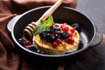 Baked or fried Camembert or brie cheese with berry and honey. Gourmet Breakfast. Selective focus