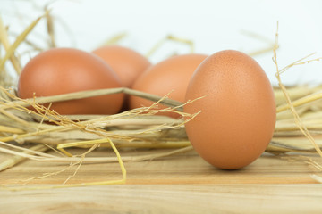 Close-up view of raw chicken eggs  on  wooden background.