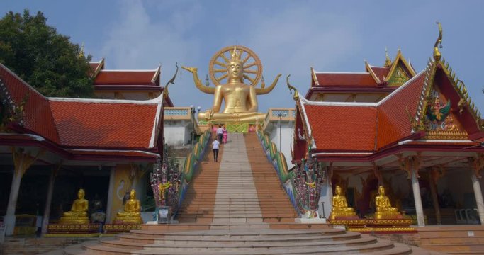 Smiling Big Buddha Sitting on Top of Stairs Awaits Tourists to Come and Meditate, Thailand, 4K
