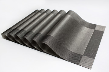 Gray placemats arranged on a white background.
