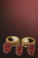 Assortment of cakes with chocolate, jam, marmalade, puffs, marshmallows on a tray