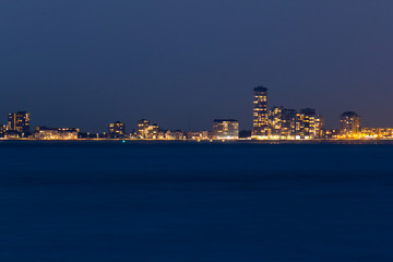 The skyline of Vlissingen and the estuary of the Scheldt river after sunset
