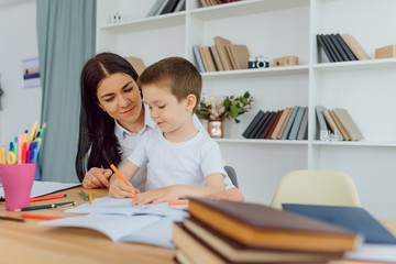 Fototapeta premium Tutor with pupil. Little girl studying. Private lesson.