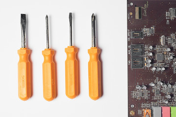 Set of screwdrivers on a white background top view, screwdrivers for repair, uniform background, advertising, repair tools with a chip motherboard tools for computer repair