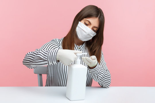Hygiene, preventive measures during coronavirus quarantine. Woman employee pumping sanitizer, washing hands with soap, antiseptic gel. Disinfection at workplace, home office while covid-19 epidemic