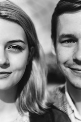 Closeup of a woman and a man who are looking at the camera.