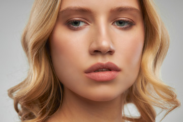 Obraz premium Beautiful face of young attractive blonde with nude makeup.