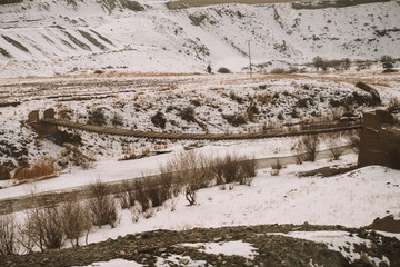 Red diesel train (East express) in motion at the snow covered railway platform - The train connecting Ankara to Kars - Turkey