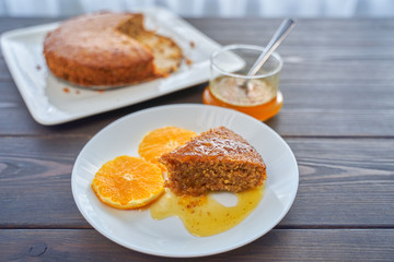 Homemade orange cake on a dark wooden kitchen table. Vegan and Gluten Free.