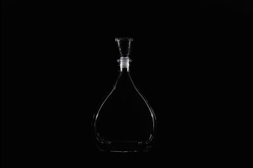 Transparent bottle as a drop on a black background