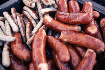 Fototapeta premium Grilling sausages. Open picnic season 