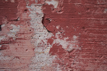 Old Cracked red and white concrete wall texture. Old cracked weathered red white painted texture.