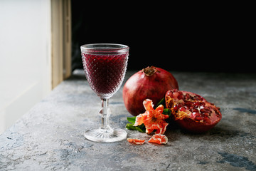 Pomegranate juice and fruits with flowering branches