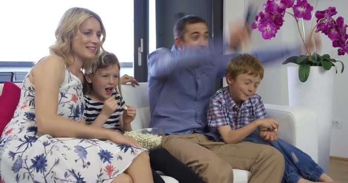 4K Medium Shot Of Family Celebrating Win Of Their Favourite Sports Team On TV