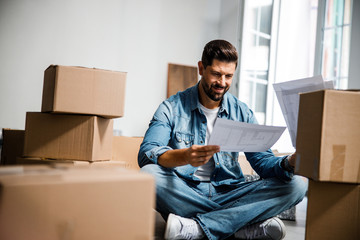 Cheerful bearded man moving to new apartment