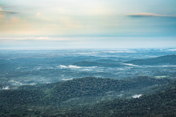mountain horizon coverd with white mists and dense forests