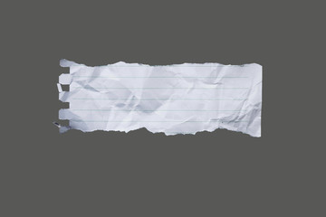 Fototapeta White ripped striped note, copybook, notebook paper stuck on light gray,black background. obraz