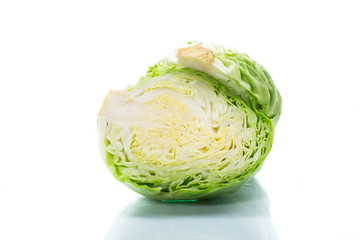early green cabbage cut in half swing on a white background
