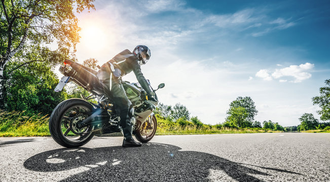 motorbike on the road riding. having fun riding the empty road on a motorcycle tour / journey © AA+W