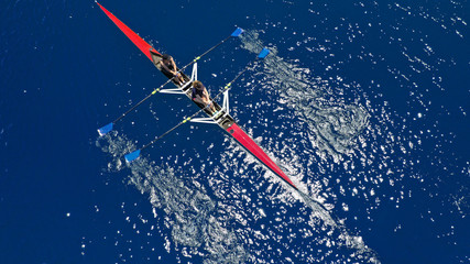 Naklejka premium Aerial drone photo of women athletes exercising sport canoe in open ocean deep blue sea