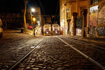 Night view of the Lisbon tram with graffiti.