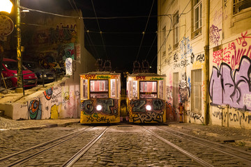 Night view of the Lisbon tram with graffiti.