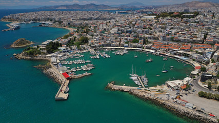 Fototapeta na wymiar Aerial drone bird's eye view panoramic photo of iconic round shaped picturesque port of Mikrolimano with sail boats and yachts docked, Piraeus port, Attica, Greece