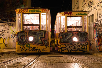 Night view of the Lisbon tram with graffiti.
