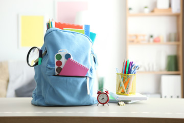 school backpack and stationery in a bright room. Preparing for school. Back to school. Place for text. National School Backpack Awareness Day
