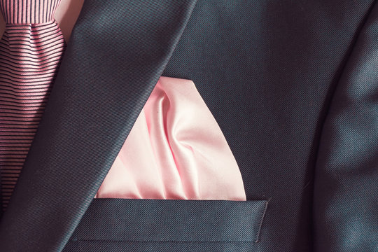.Formal dark blue suit with a pink tie and scarf. .Blue suit for the groom