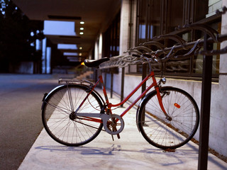 Fototapeta na wymiar Lone red bike parked in a desolated place