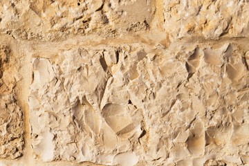 Wall sandstone texture background. Yellow old grunge surface, stone vintage texture. Voluminous background