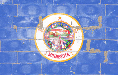 Minnesota state national flag round shape on blue background of old painted brick wall on Independence Day wall street graffiti. Political and religious disputes, customs and delivery.