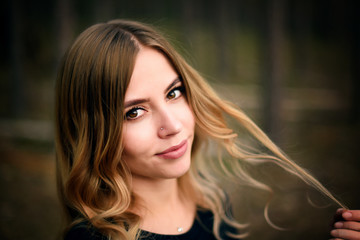 Obraz premium A beautiful young girl in fir tree forest