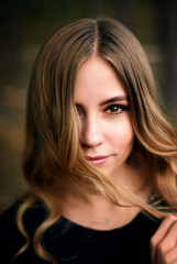 Fototapeta premium A beautiful young girl in fir tree forest