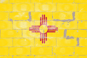 National flag of US state of New Mexico, the red sun sign, Zia symbol, yellow on Independence Day,...