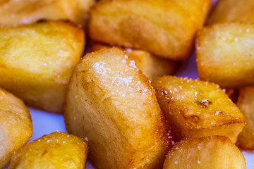Salted deep fried potatoes on a plate