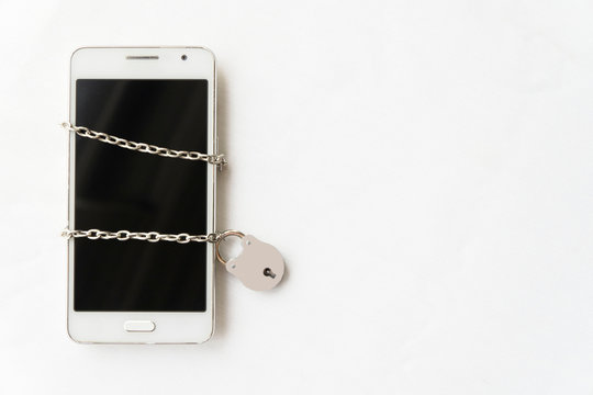 Censored Mobile Phone With Chains And Padlock. Technological Detoxification Concept.