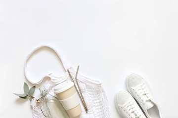 Bag shopping bag reusable travel mug, vacuum Cup to the glass bottle, a metal tube, white sneakers. The zero waste concept.