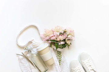 Bag string bag with peony flowers, reusable thermocup, vacuum Cup, glass bottle, metal tubes, white sneakers.