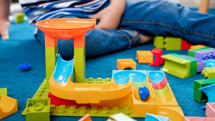 Closeup image of colorful track for marble run in playroom