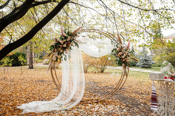 Round wedding arch decorated with flowers