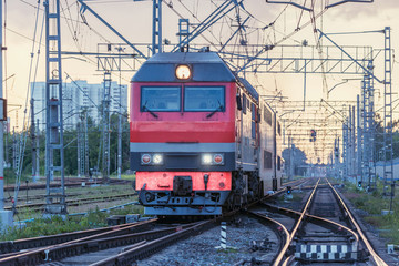 Obraz na płótnie Canvas Passenger train departs at sunset time. Moscow.
