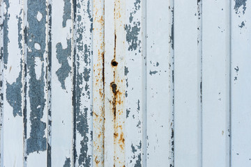 Metal aged door. Cracked white paint. Rusty lock.