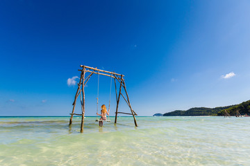 Young woman on swing Phu Quoc